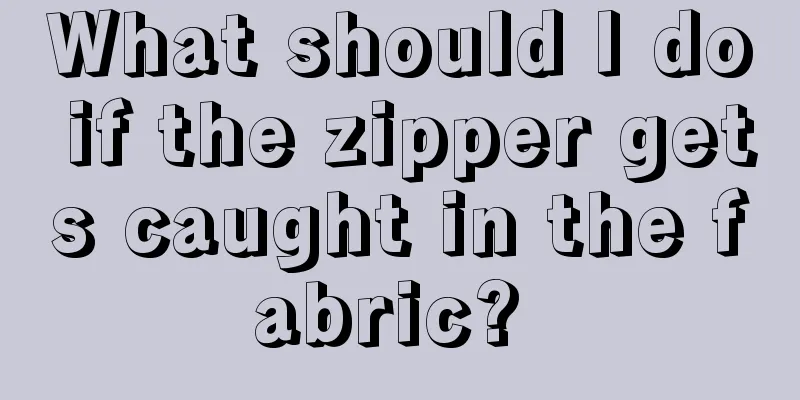 What should I do if the zipper gets caught in the fabric? 