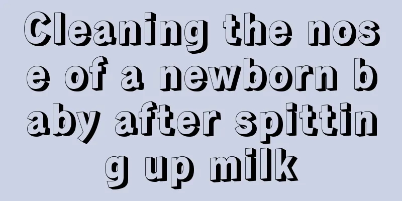 Cleaning the nose of a newborn baby after spitting up milk