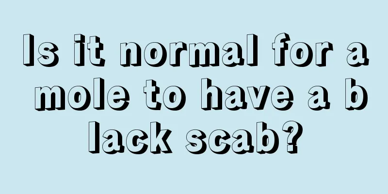 Is it normal for a mole to have a black scab?